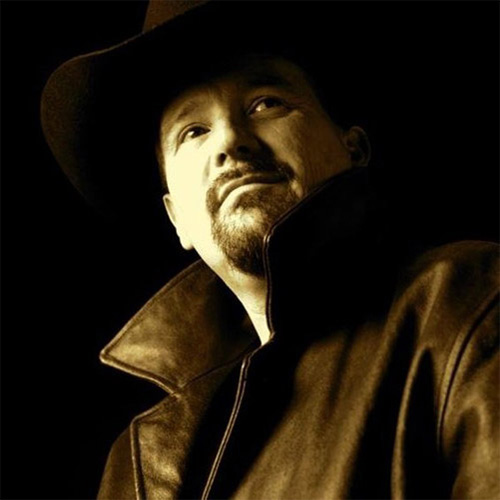 A portrait of Thad Foster in a hat and a leather jacket.